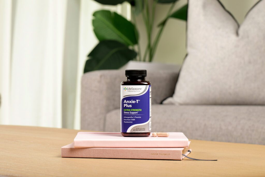 anxie-t stress supplement support sitting on a coffee table on top of a notebook
